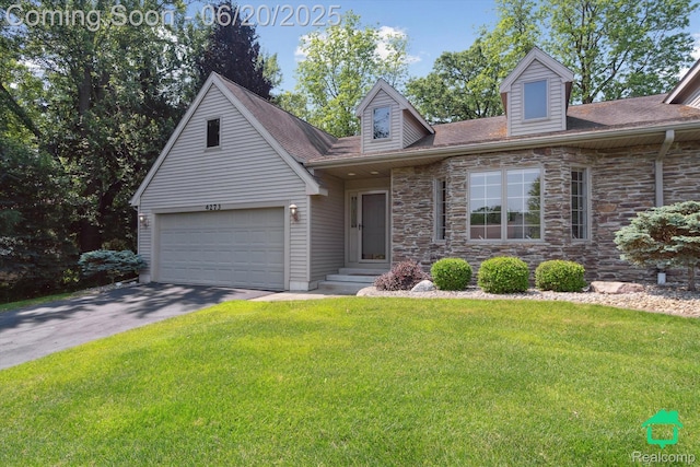 4273 Fairway Ln, Jackson, MI 49201 - view of front of house featuring asphalt driveway, a front lawn, stone siding, and a shingled roof