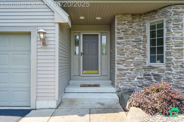 4273 Fairway Ln, Jackson, MI 49201 - entrance to property with stone siding and an attached garage
