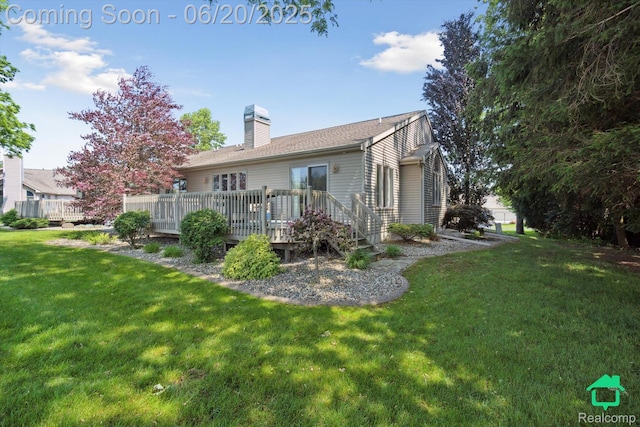 4273 Fairway Ln, Jackson, MI 49201 - back of property with a chimney, a lawn, and a deck