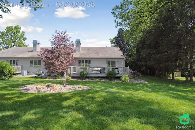 4273 Fairway Ln, Jackson, MI 49201 - rear view of property featuring a wooden deck, a lawn, and a chimney