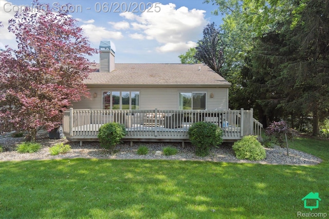 4273 Fairway Ln, Jackson, MI 49201 - rear view of house with a chimney, a lawn, a deck, and roof with shingles