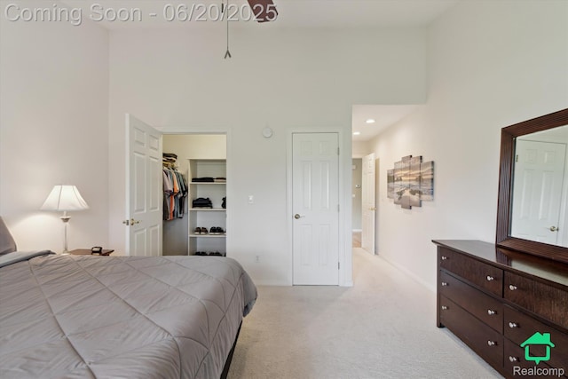 4273 Fairway Ln, Jackson, MI 49201 - bedroom featuring light colored carpet, a high ceiling, a spacious closet, and recessed lighting