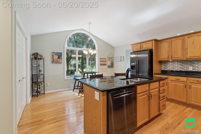 4273 Fairway Ln, Jackson, MI 49201 - kitchen featuring stainless steel dishwasher, refrigerator with ice dispenser, vaulted ceiling, light wood-style flooring, and a chandelier