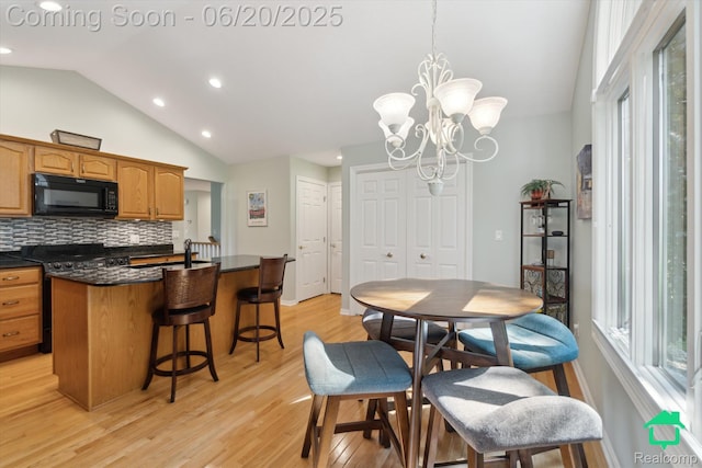 4273 Fairway Ln, Jackson, MI 49201 - dining room with lofted ceiling, light wood-style flooring, recessed lighting, plenty of natural light, and a chandelier