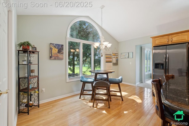 4273 Fairway Ln, Jackson, MI 49201 - dining room featuring healthy amount of natural light, lofted ceiling, light wood-style floors, and a chandelier