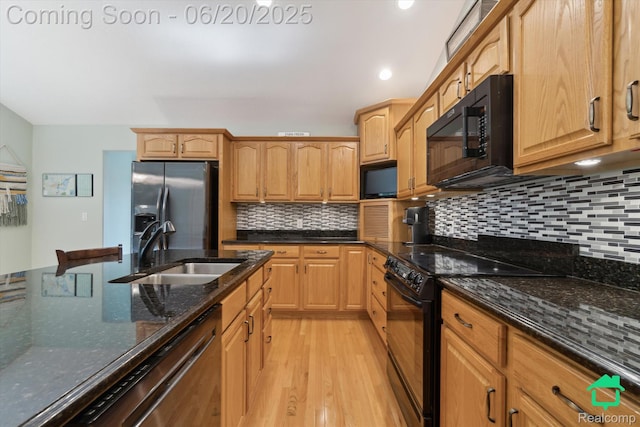 4273 Fairway Ln, Jackson, MI 49201 - kitchen featuring black appliances, decorative backsplash, light wood-style floors, dark stone counters, and recessed lighting