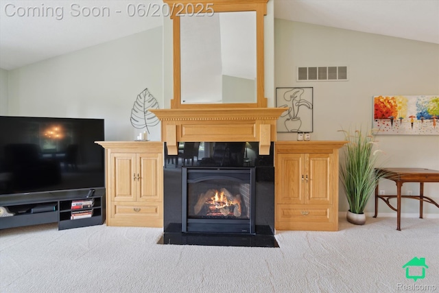4273 Fairway Ln, Jackson, MI 49201 - living room featuring lofted ceiling, carpet, and a fireplace with flush hearth