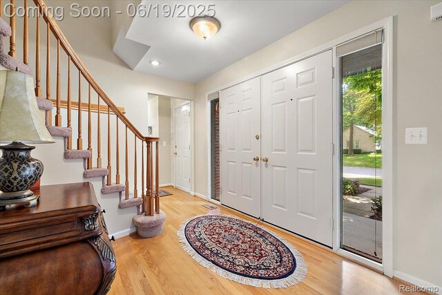 2082 Avon Lake Ln, Rochester Hills, MI 48307 - entrance foyer with light wood-style floors and stairway