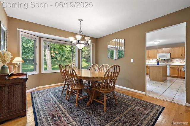 2082 Avon Lake Ln, Rochester Hills, MI 48307 - dining area with a chandelier and light wood-type flooring