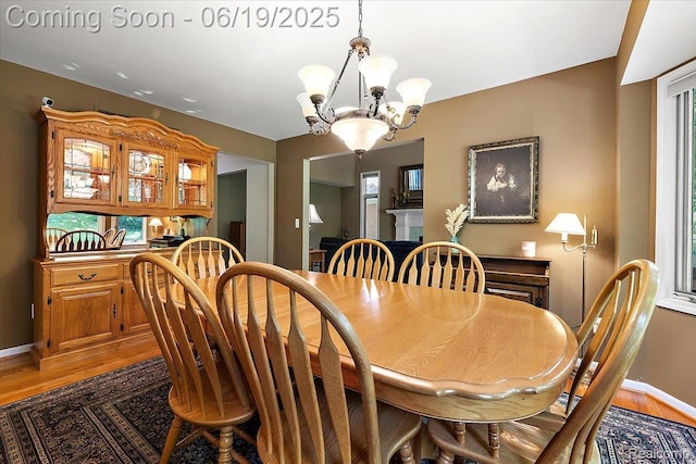 2082 Avon Lake Ln, Rochester Hills, MI 48307 - dining area featuring light wood-style floors, a chandelier, and healthy amount of natural light