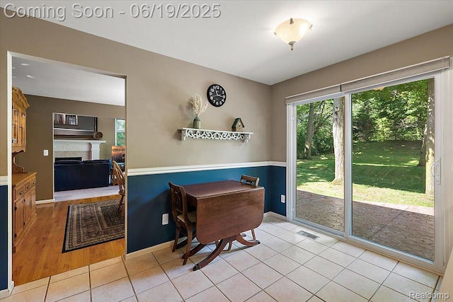 2082 Avon Lake Ln, Rochester Hills, MI 48307 - dining room with a fireplace and tile patterned flooring