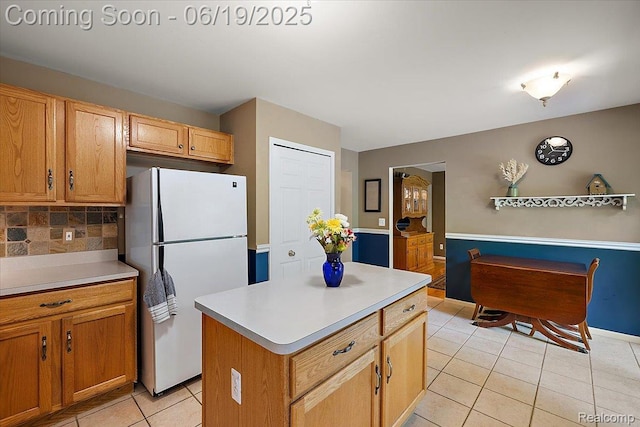 2082 Avon Lake Ln, Rochester Hills, MI 48307 - kitchen featuring freestanding refrigerator, light tile patterned floors, backsplash, and light countertops