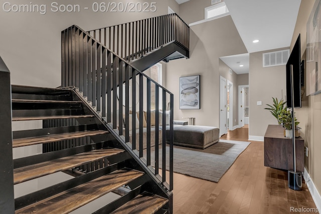 2648 John R St, Detroit, MI 48201 - staircase featuring wood-type flooring, recessed lighting, and a towering ceiling