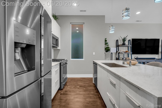 2648 John R St, Detroit, MI 48201 - kitchen featuring stainless steel appliances, modern cabinets, white cabinets, dark wood-style flooring, and light stone countertops