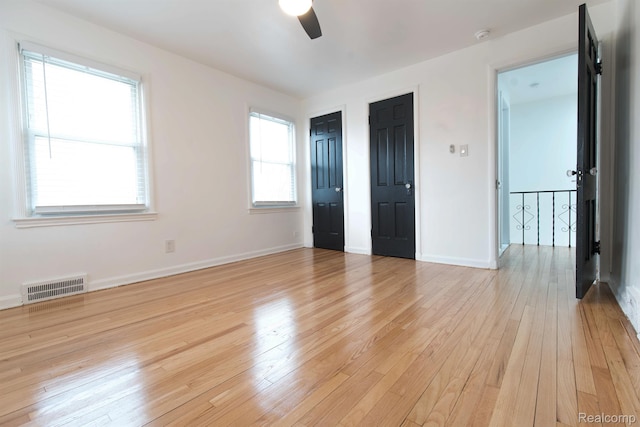 15821 Kentfield St, Detroit, MI 48223 - unfurnished bedroom with light wood finished floors, two closets, and a ceiling fan