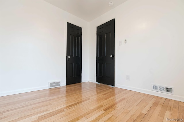 15821 Kentfield St, Detroit, MI 48223 - empty room with light wood-type flooring and a smoke detector