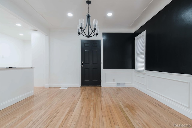 15821 Kentfield St, Detroit, MI 48223 - empty room featuring a chandelier, hardwood / wood-style flooring, wainscoting, and recessed lighting