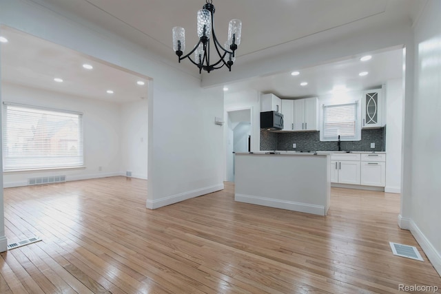 15821 Kentfield St, Detroit, MI 48223 - kitchen with a chandelier, white cabinets, light wood-style flooring, plenty of natural light, and recessed lighting