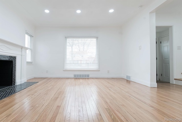 15821 Kentfield St, Detroit, MI 48223 - unfurnished living room with light wood-style floors, a fireplace, and recessed lighting