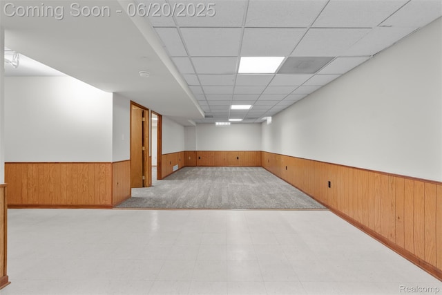 2206 Estates Dr, Highland, MI 48357 - spare room featuring a wainscoted wall, wooden walls, and a drop ceiling