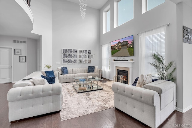 50432 Maywood, Dearborn, MI 48188 - living area with a towering ceiling, a glass covered fireplace, and dark wood finished floors