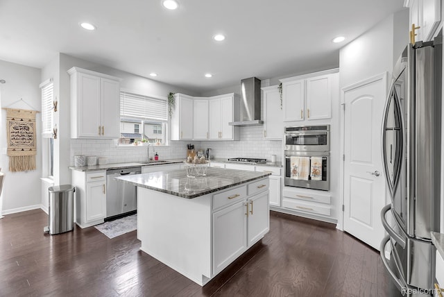 50432 Maywood, Dearborn, MI 48188 - kitchen featuring appliances with stainless steel finishes, wall chimney exhaust hood, dark wood-style floors, decorative backsplash, and white cabinets