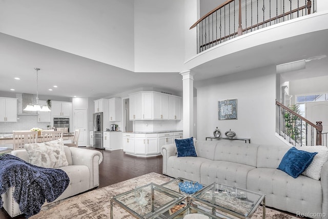 50432 Maywood, Dearborn, MI 48188 - living room featuring dark wood finished floors, stairway, a high ceiling, recessed lighting, and a chandelier