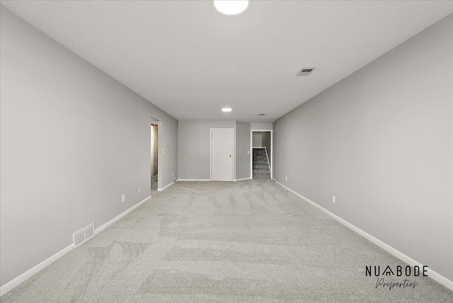 1427 Atlantic St NW, Grand Rapids, MI 49504 - spare room featuring light colored carpet, a textured ceiling, and recessed lighting