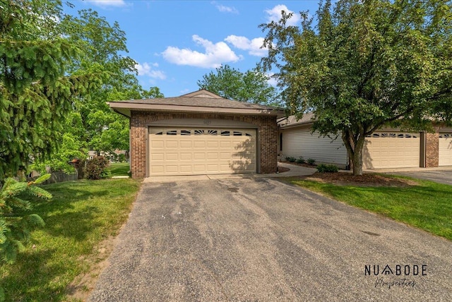 1427 Atlantic St NW, Grand Rapids, MI 49504 - view of front of property with brick siding, driveway, a garage, and a front lawn