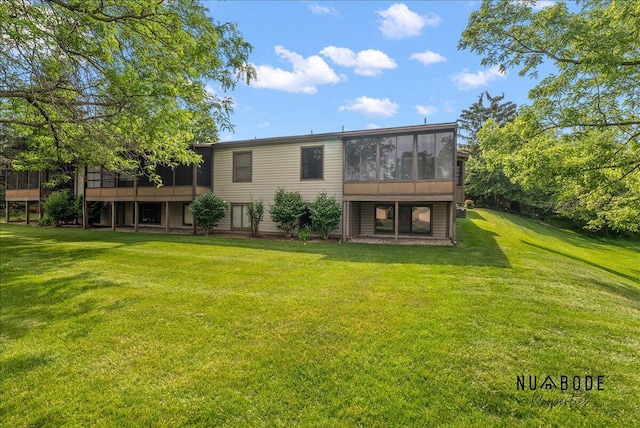 1427 Atlantic St NW, Grand Rapids, MI 49504 - back of property with a sunroom, a yard, and a deck