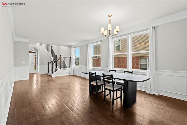 945 Reef Dr, Canton, MI 48187 - dining room with crown molding, a chandelier, stairs, dark wood finished floors, and a decorative wall