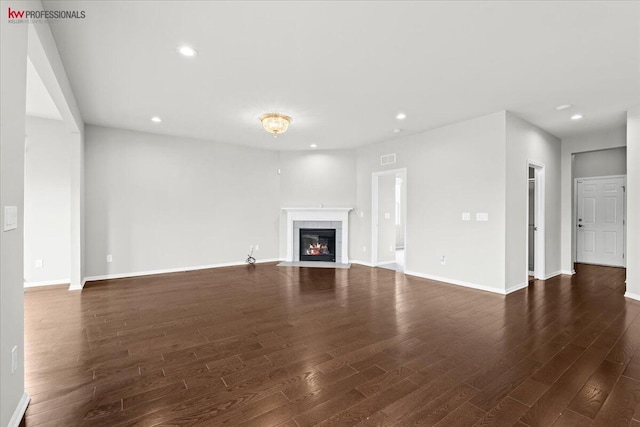 945 Reef Dr, Canton, MI 48187 - unfurnished living room featuring dark wood-style flooring, a tile fireplace, and recessed lighting