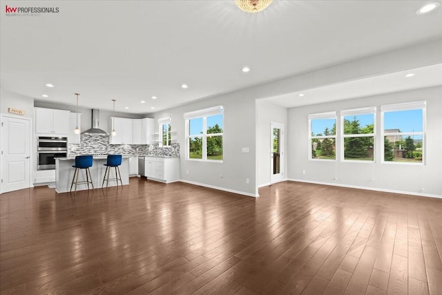 945 Reef Dr, Canton, MI 48187 - unfurnished living room with recessed lighting and dark wood-style floors