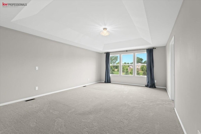 945 Reef Dr, Canton, MI 48187 - empty room with a tray ceiling and carpet