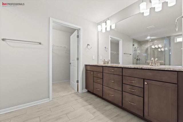 945 Reef Dr, Canton, MI 48187 - full bathroom featuring a stall shower, double vanity, and a walk in closet