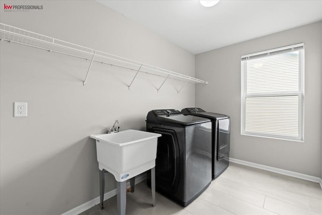 945 Reef Dr, Canton, MI 48187 - laundry area featuring washing machine and dryer and light tile patterned floors