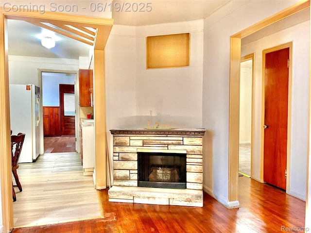 20760 Atlantic Ave, Warren, MI 48091 - detailed view of freestanding refrigerator, wood finished floors, and a fireplace