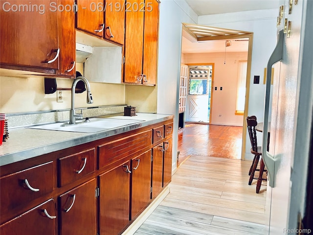20760 Atlantic Ave, Warren, MI 48091 - kitchen with light wood finished floors, light countertops, and brown cabinets