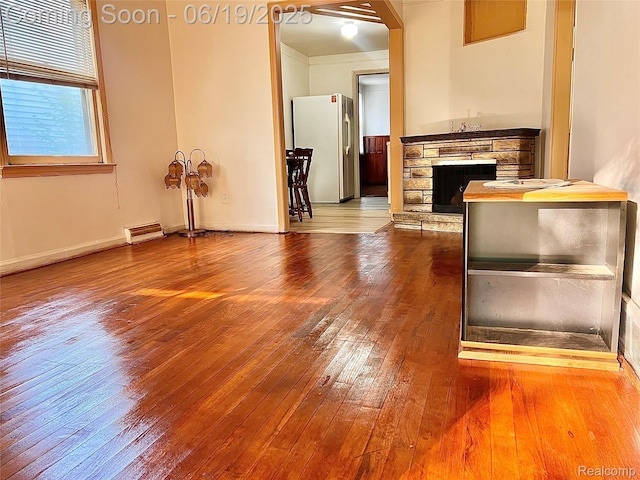 20760 Atlantic Ave, Warren, MI 48091 - unfurnished living room with wood-type flooring and a fireplace