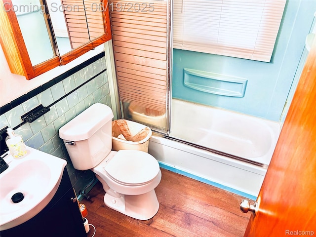 20760 Atlantic Ave, Warren, MI 48091 - full bath with combined bath / shower with glass door, wood-type flooring, vanity, and tile walls