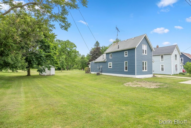 204 Maple St, Durand, MI 48429 - back of house with a yard and a storage shed