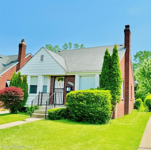 15684 Manning St, Detroit, MI 48205 - view of front of home featuring an attached garage, a front yard, brick siding, and a chimney