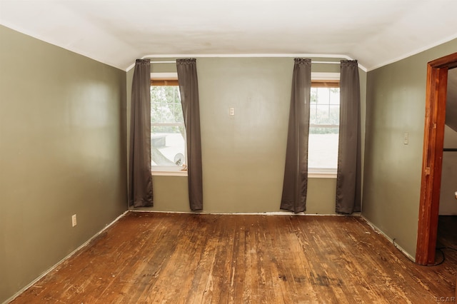 8667 Thompson Hwy, Blissfield, MI 49228 - unfurnished room with vaulted ceiling, hardwood / wood-style flooring, and ornamental molding