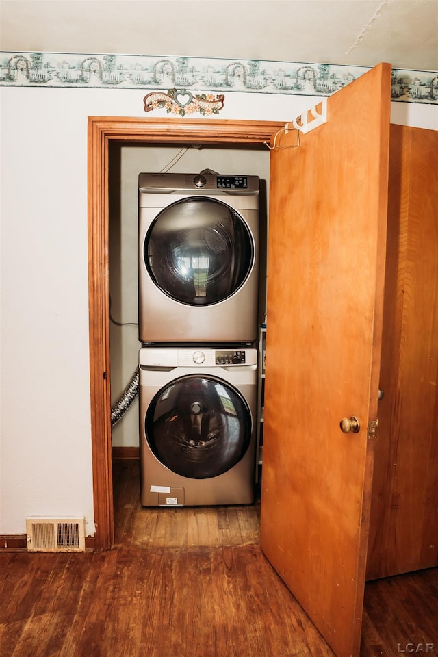 8667 Thompson Hwy, Blissfield, MI 49228 - washroom featuring stacked washing machine and dryer and wood finished floors