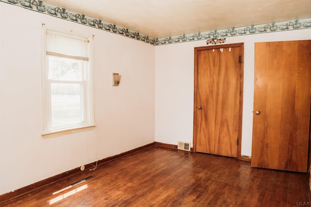 8667 Thompson Hwy, Blissfield, MI 49228 - unfurnished bedroom with dark wood finished floors and baseboards