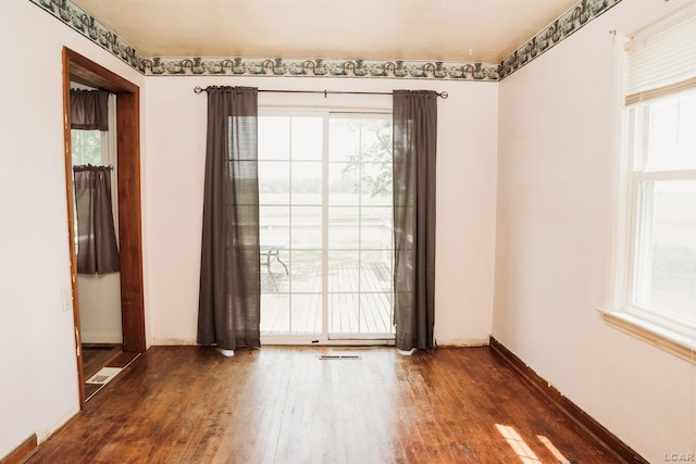 8667 Thompson Hwy, Blissfield, MI 49228 - spare room featuring wood finished floors and plenty of natural light
