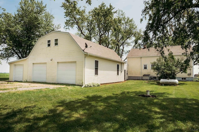 8667 Thompson Hwy, Blissfield, MI 49228 - view of home's exterior with a garage, an outdoor structure, a yard, and roof with shingles