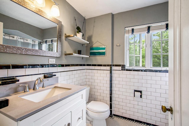 1515 E Stadium Blvd, Ann Arbor, MI 48104 - bathroom with tile walls, vanity, tile patterned floors, and wainscoting
