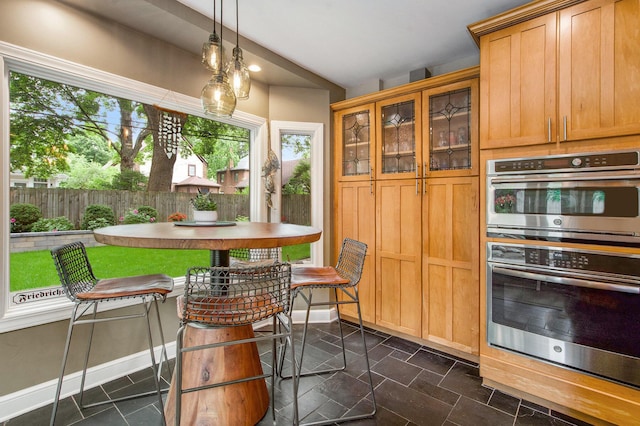 1515 E Stadium Blvd, Ann Arbor, MI 48104 - kitchen with double oven, pendant lighting, and glass insert cabinets