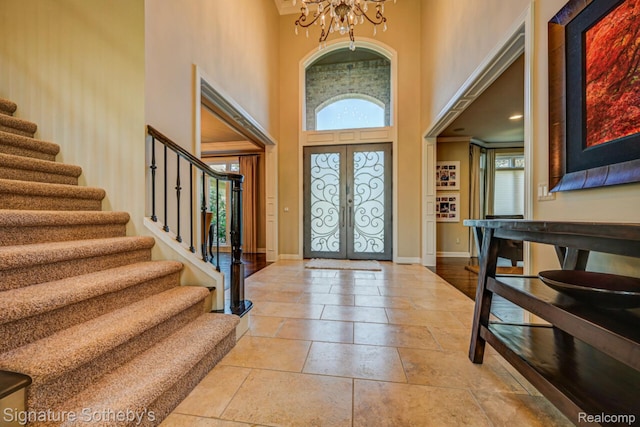 3225 Legacy Ct, West Bloomfield, MI 48323 - entrance foyer with a towering ceiling, stairs, a chandelier, stone tile floors, and french doors